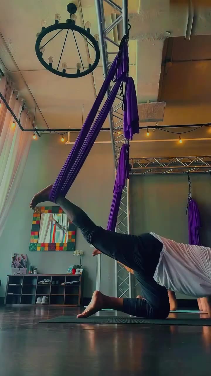 Aerial yoga in purple silks at Yoga Loft Tampa in Ybor City