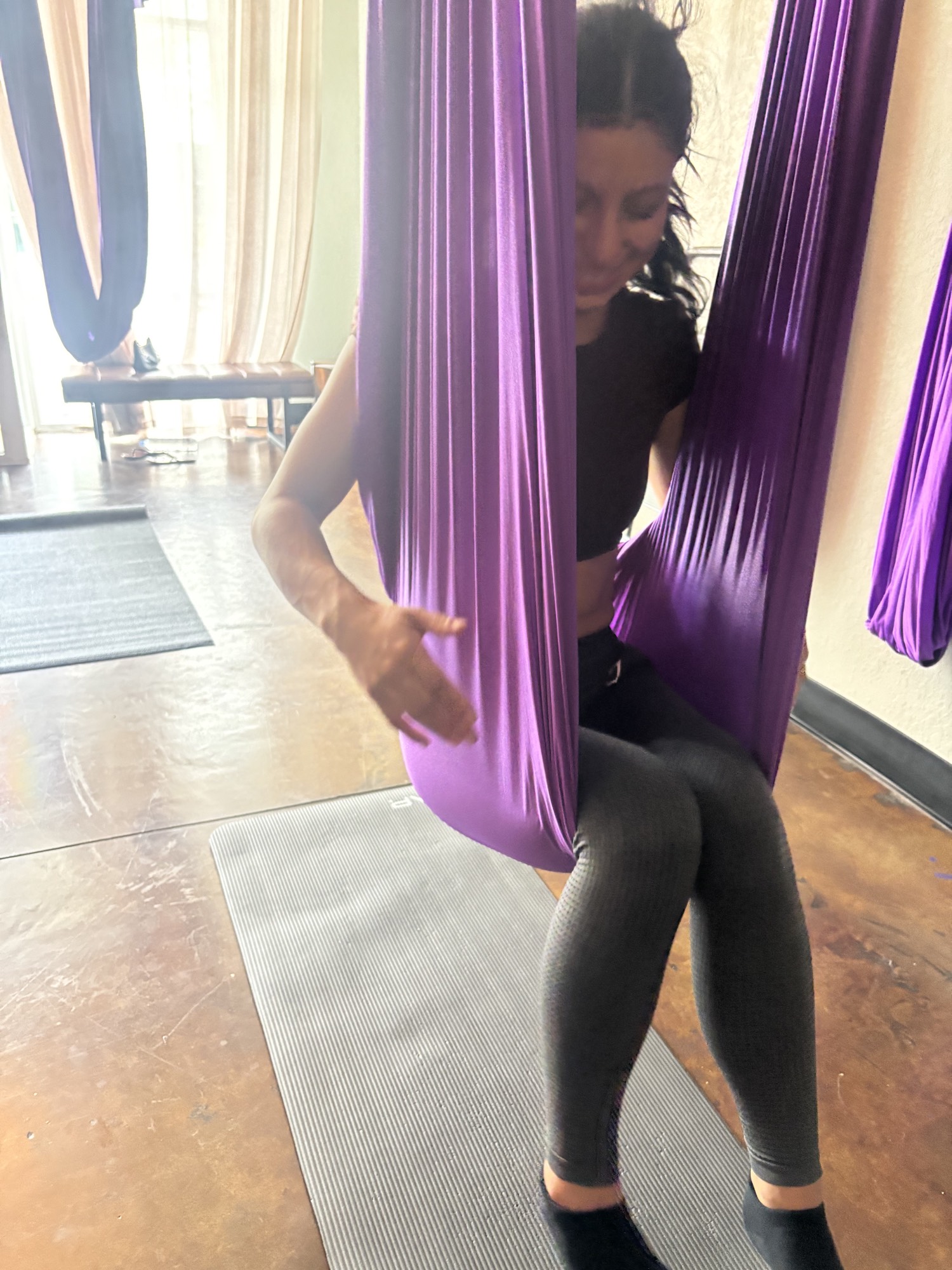 Resting in a purple aerial hammock at Yoga Loft Tampa